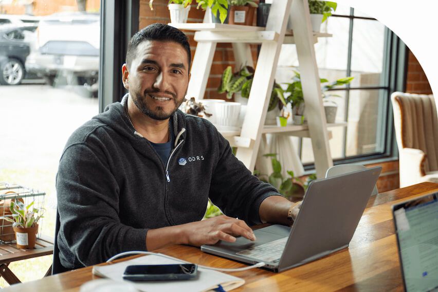 Erik Ibarra, CEO and founder of ORDRS, at desk on laptop